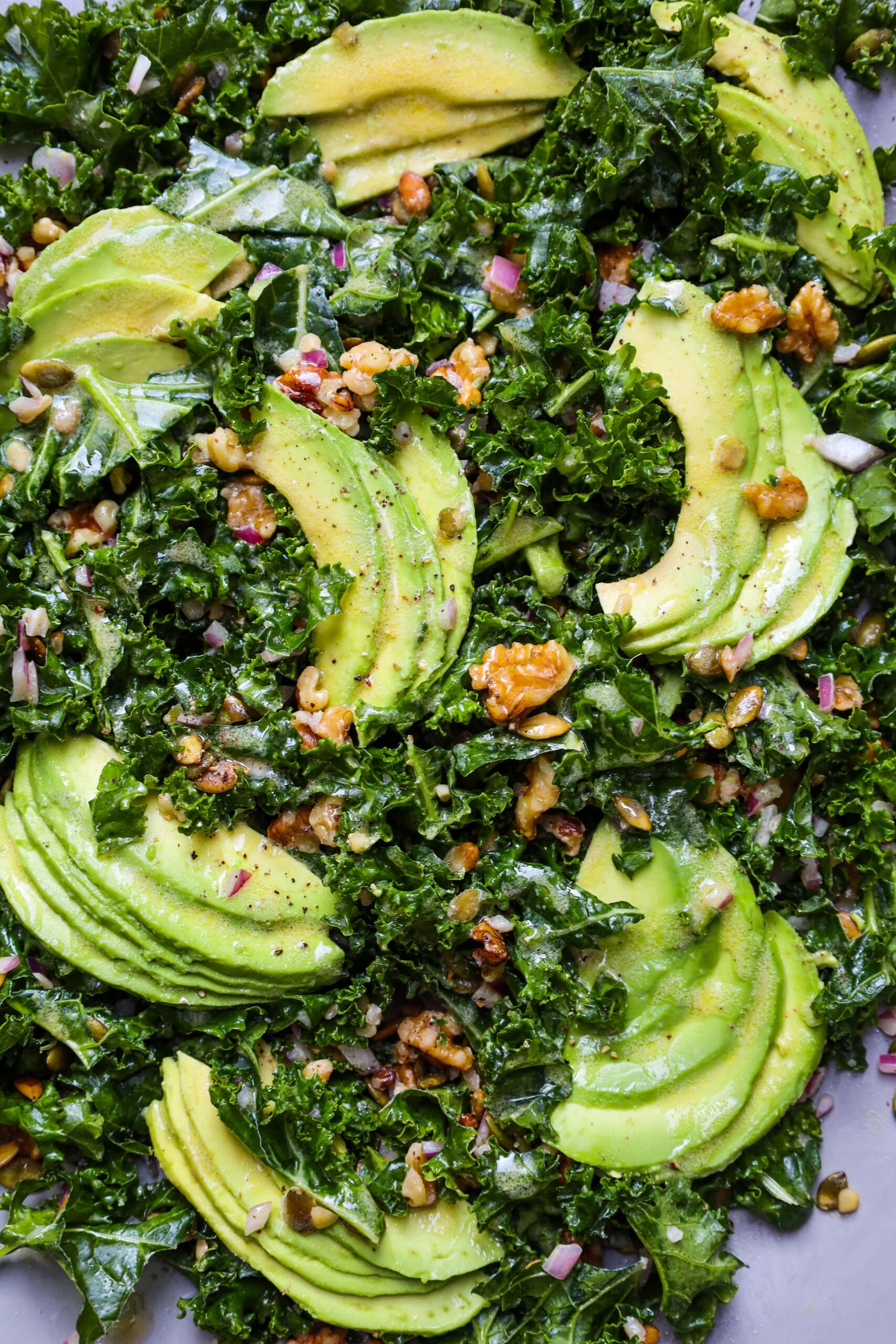 kale salad with walnuts, pumpkin seeds avocado and dijon vinaigrette