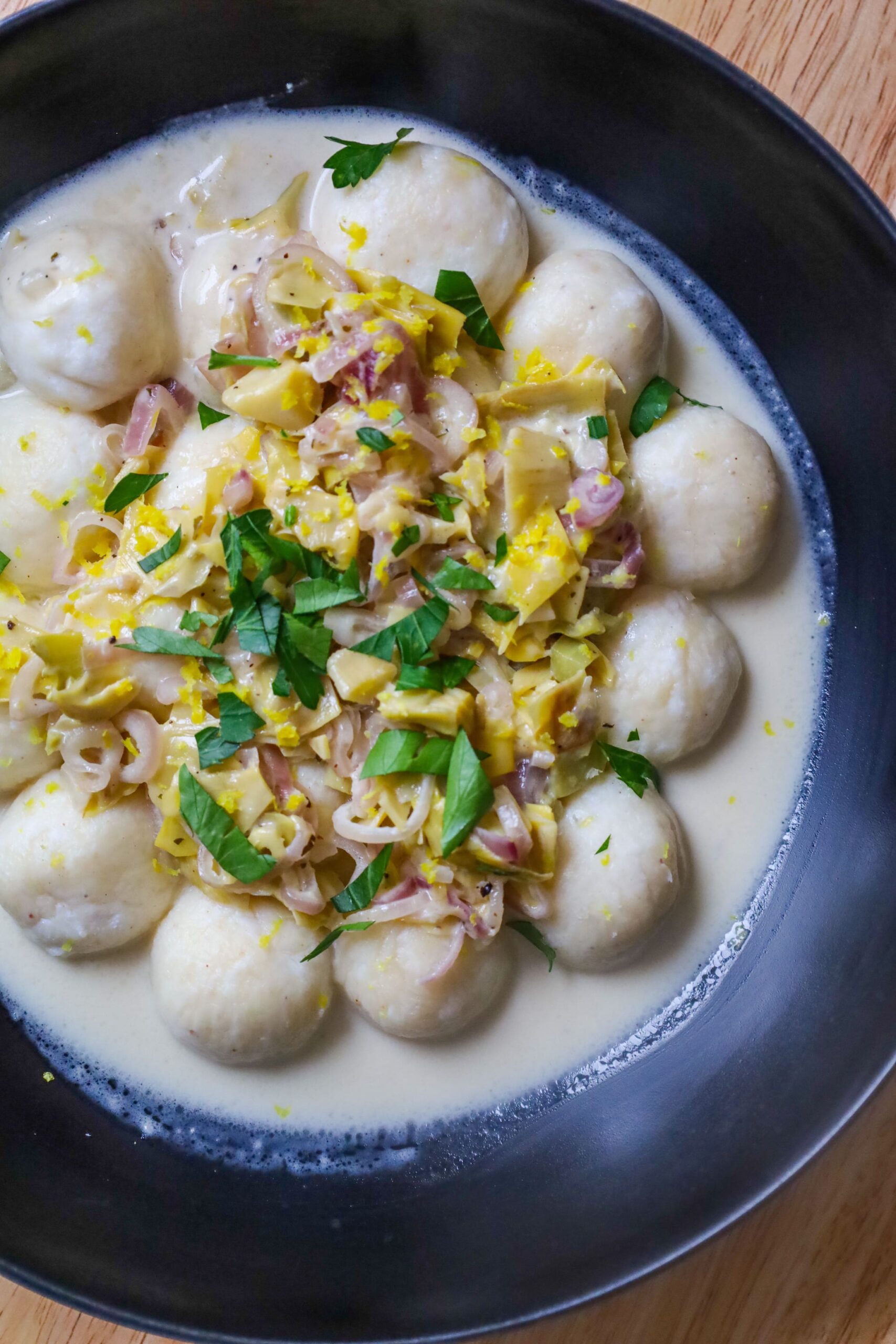 ricotta gnudi with creamy artichokes and shallots